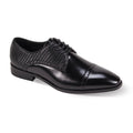 Black dress shoe with textured side panel on a white background