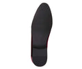 Black shoe sole with red lining on a white background