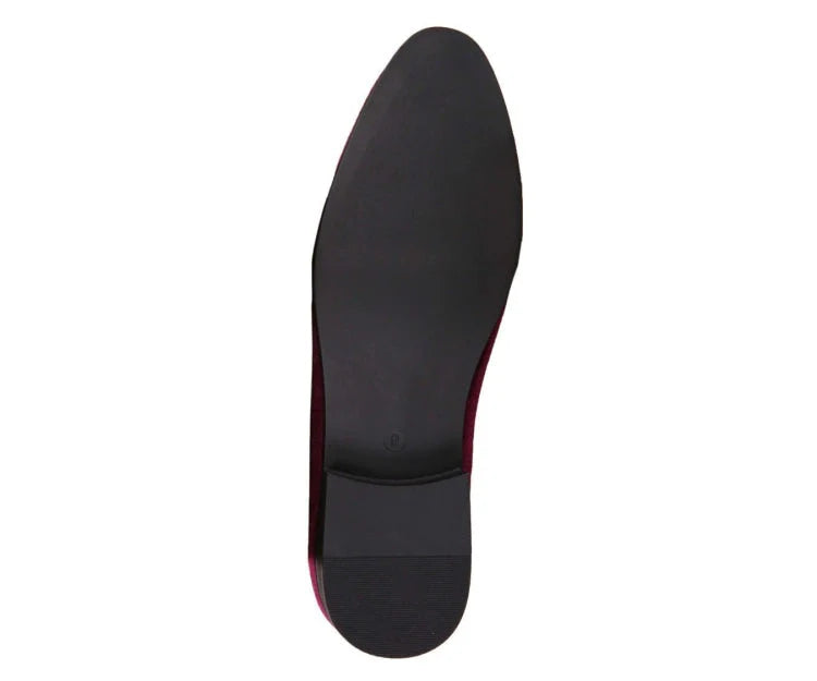 Black shoe sole with red lining on a white background