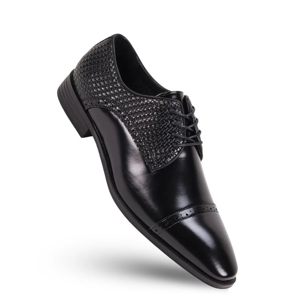 Black dress shoe with decorative bow on a white background