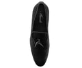 Black velvet loafer with decorative buckle on a white background