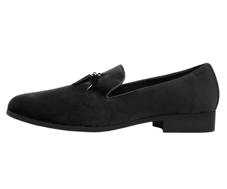 Black suede loafer with a silver buckle on a white background
