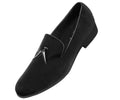 Black suede loafer with a silver buckle on a white background