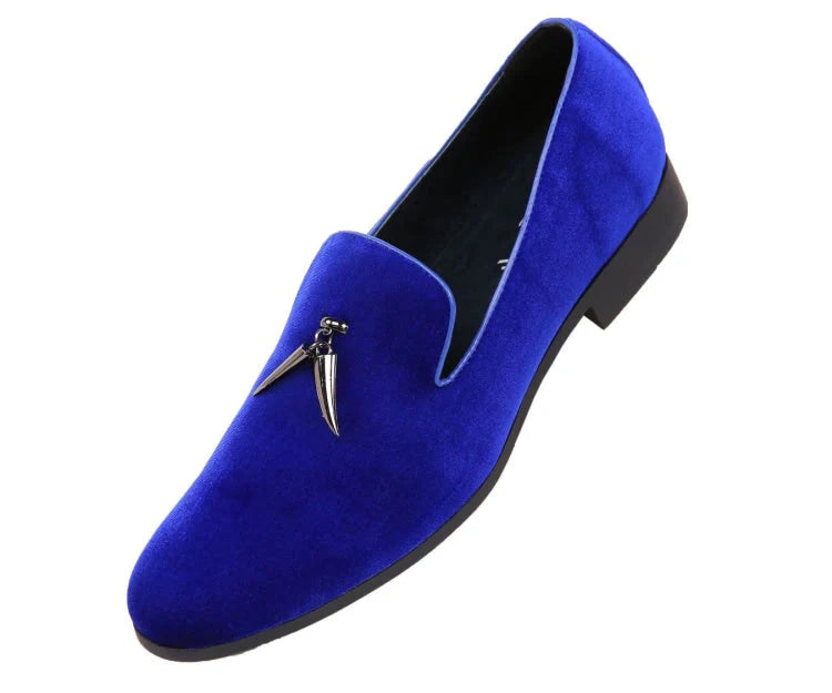 Blue velvet loafer with a decorative clasp on a white background