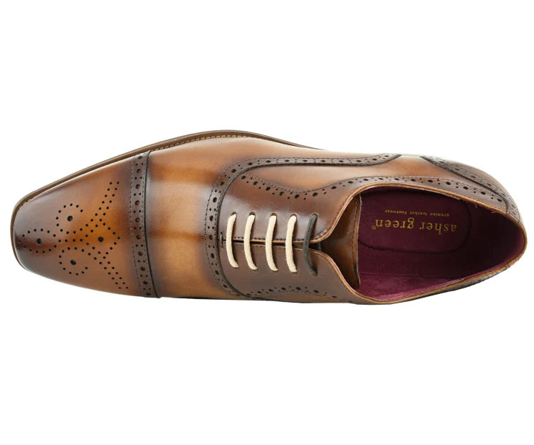 Brown leather dress shoe with detailed design on a white background